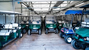 Interior view of a warehouse with golf carts