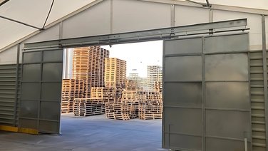 Interior view of the sliding steel door of an industrial tent