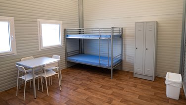 Interior view of a residential unit with bunk beds and furnishings
