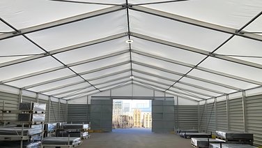Interior view of an industrial tent with a view of a steel sliding gate