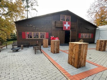 Wooden-look party tent with standing blocks in front of it