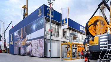 View on the side with construction machines and alea facade tensioning system