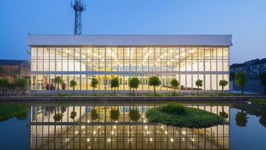 Front exterior view of Wuzhen Art Gallery with pond in the foreground