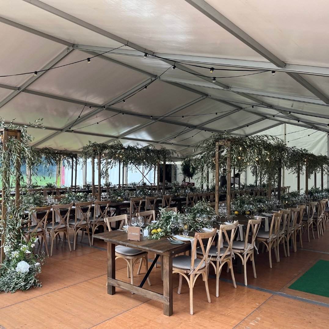 Event tent for a wedding celebration with elaborate decorations and seating