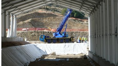 Interior view of a waste storage hall during construction with different side heights