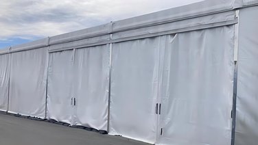 Side view of a storage tent with PVC side tarpaulin doors