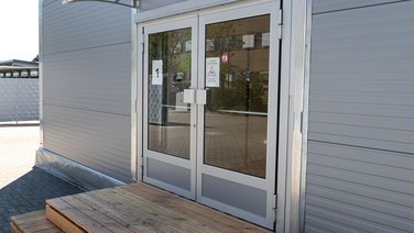 Exterior view of the double doors of a refugee centre