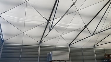 Interior view of an industrial tent with a tarpaulin
