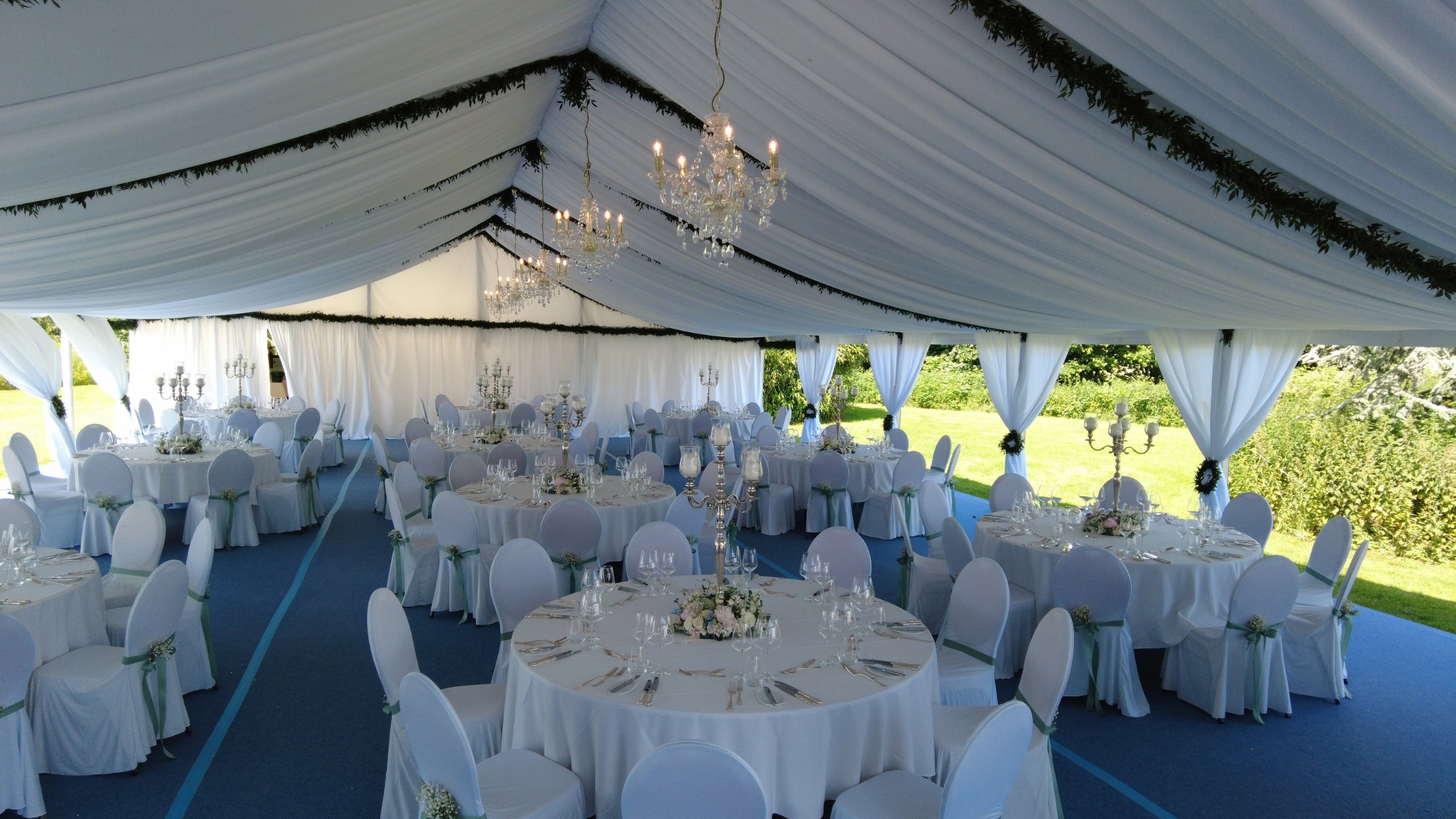 Marquee with gala round tables and open side curtains