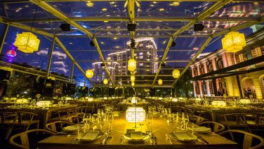 Interior view from the side of the gala tables at a company event