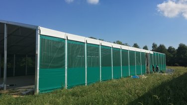 Side view of an indoor riding arena during construction