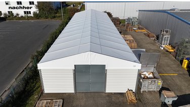 Birds eye view of an industrial hall with tarpaulin roof and trapezoidal sheet facade