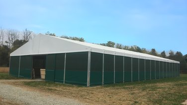 Front of an indoor riding arena with gate entrance