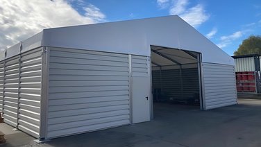 Front view of an industrial tent with a view of a steel sliding gate