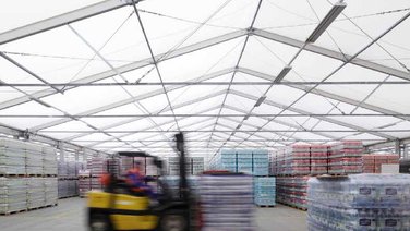 Interior view of the warehouse with goods and forklift truck
