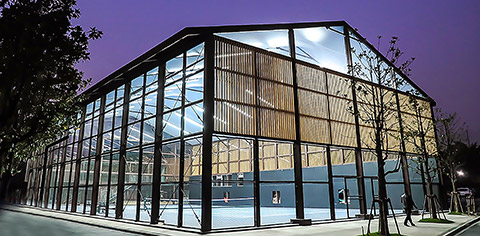 teaser image as exterior view of a glass sports facility for tennis