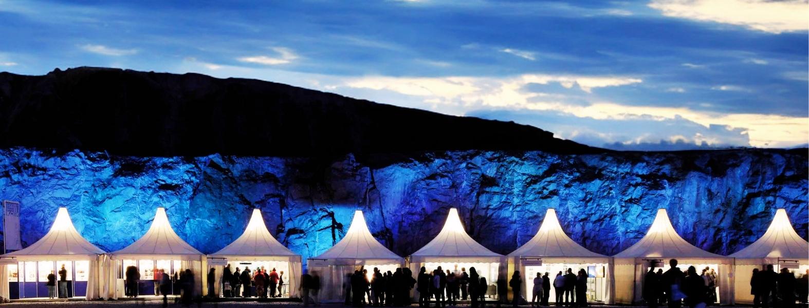 Several RÖDER pagoda tents in a former lime mine at night