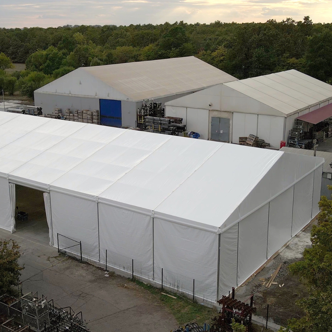 Bird's eye view of the roof and a side door of a rental hall with a PVC tarpaulin roof