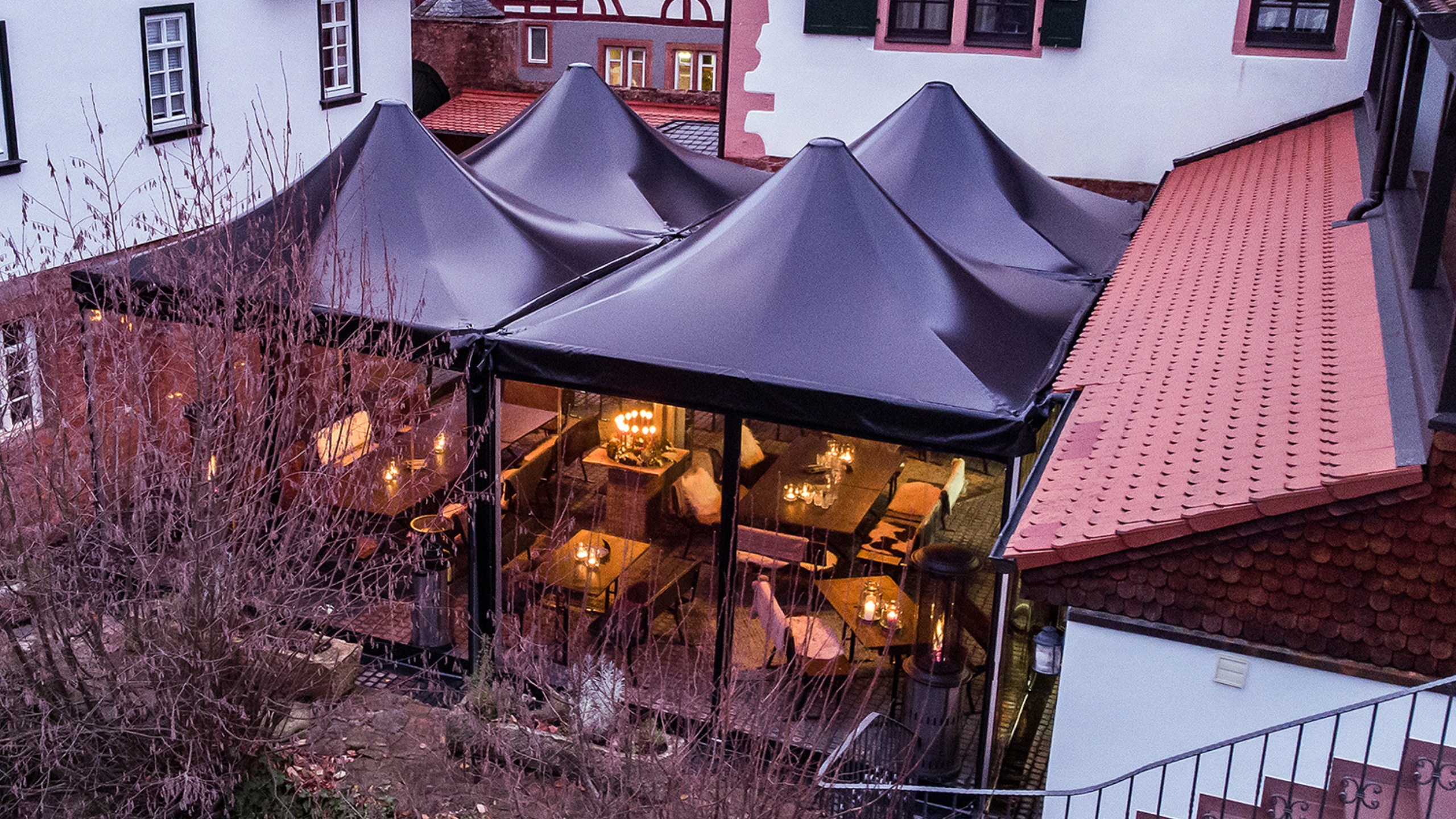 Bird's eye view of 4 event tents as roofing for an open area of a restaurant
